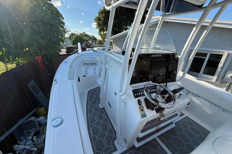 Slide: The Image of 2014 Sea Fox 256 Commander boat cockpit with steering wheel and control panel. - 32