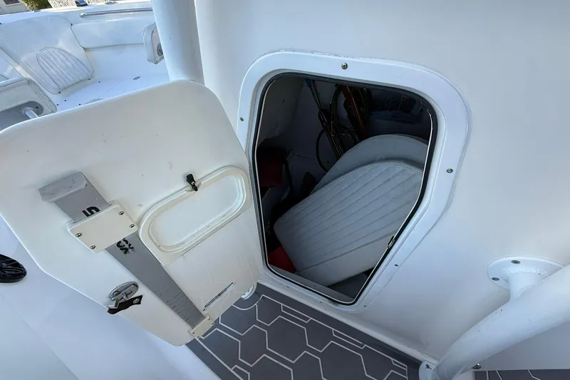 Slide: The Image of 2014 Sea Fox 256 Commander boat interior storage compartment with open door. - 34