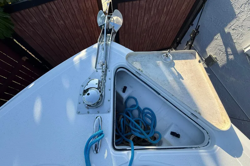 Slide: The Image of 2014 Sea Fox 256 Commander anchor compartment with blue rope and open hatch. - 40