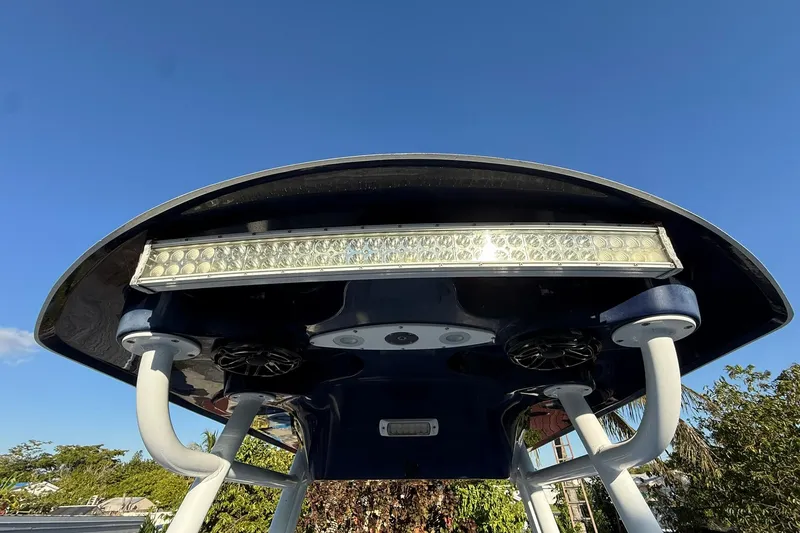Slide: The Image of T-top of 2014 Sea Fox 256 Commander with LED light bar against clear blue sky. - 49