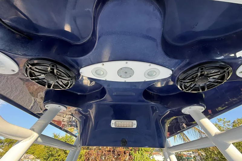 Slide: The Image of 2014 Sea Fox 256 Commander boat speakers and lights on blue canopy. - 50