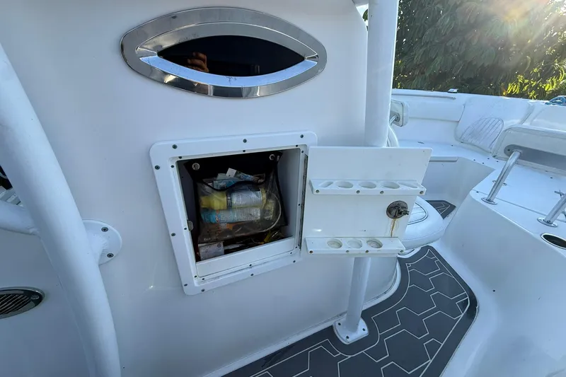 Slide: The Image of 2014 Sea Fox 256 Commander boat interior with storage compartment and rod holders. - 53