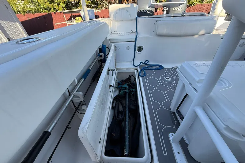 Slide: The Image of 2014 Sea Fox 256 Commander boat interior with open storage compartment and fishing gear. - 55