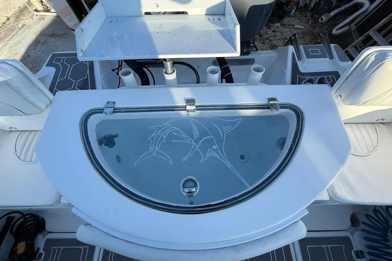 Slide: The Image of 2014 Sea Fox 256 Commander boat interior with livewell and fishing rod holders. - 60