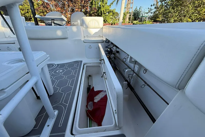 Slide: The Image of 2014 Sea Fox 256 Commander boat interior with storage and fishing rods. - 64