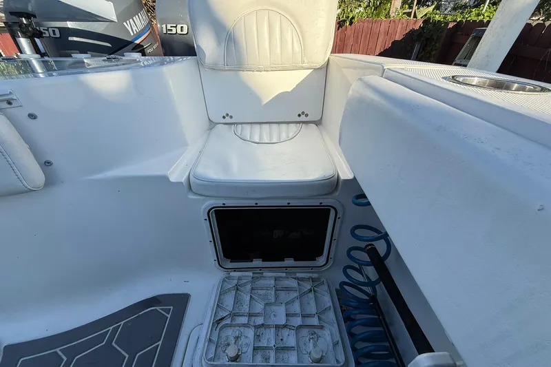 Slide: The Image of 2014 Sea Fox 256 Commander boat interior with Yamaha 150 engines, white seating, and storage compartment. - 66