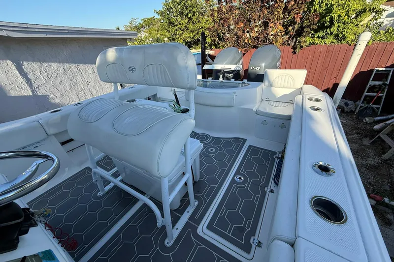 Slide: The Image of 2014 Sea Fox 256 Commander boat interior with dual engines and cushioned seating. - 68