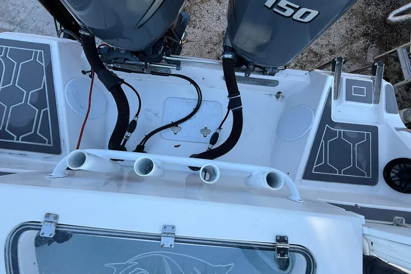 Slide: The Image of 2014 Sea Fox 256 Commander boat deck with dual 150 engines and rod holders. - 70