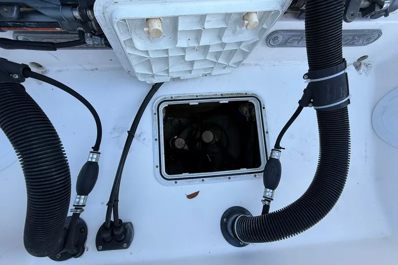 Slide: The Image of Open hatch on 2014 Sea Fox 256 Commander boat showing internal components and hoses. - 71