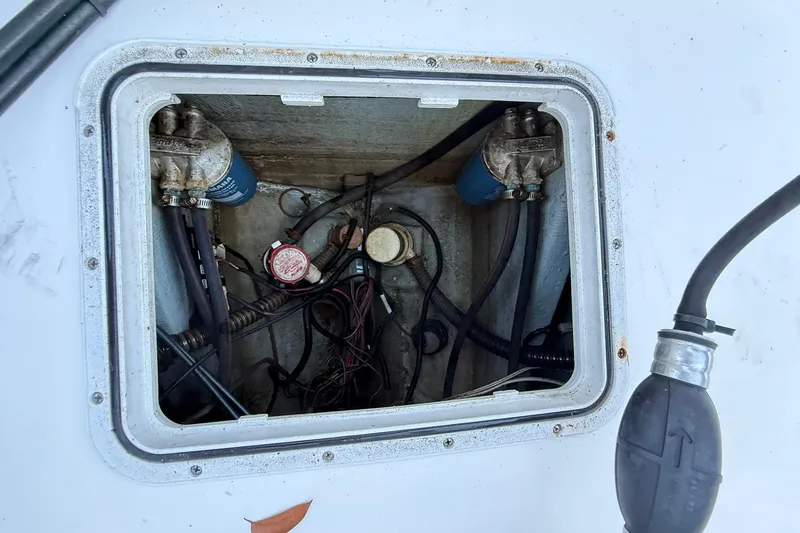 Slide: The Image of 2014 Sea Fox 256 Commander boat compartment with wiring and fuel filters visible. - 73
