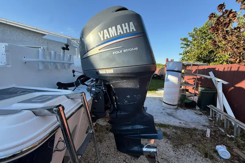 Slide: The Image of 2014 Sea Fox 256 Commander with Yamaha four-stroke outboard motor in a backyard setting. - 74