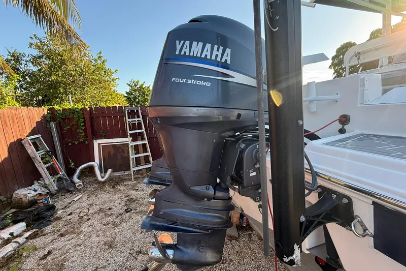 Slide: The Image of 2014 Sea Fox 256 Commander with Yamaha four-stroke outboard motor in a backyard setting. - 75