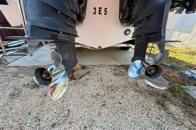 Slide: The Image of 2014 Sea Fox 256 Commander boat propellers on gravel surface. - 77