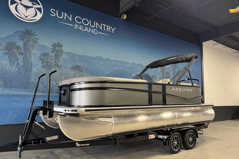 Slide: The Image of 2026 Premier 200 Sunscape RF pontoon boat on trailer at Sun Country Inland showroom. - 3