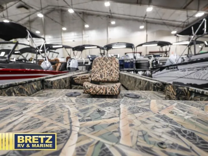 Slide: The Image of Sportsman 1866 T boat 2025 with camouflage pattern in showroom. - 7