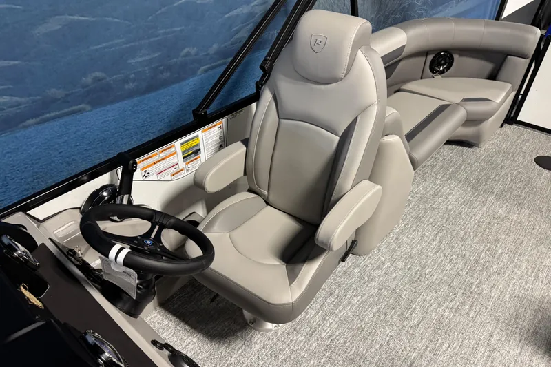Slide: The Image of 2026 Premier 220 Sunscape RF boat interior with gray captain's chair and steering wheel. - 9