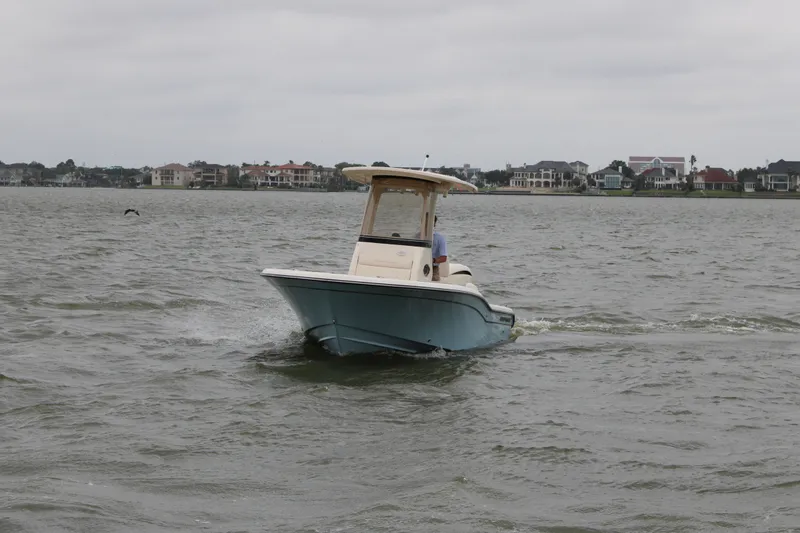 Slide: The Image of Grady-White 231 Coastal Explorer 2026 on calm waters near coastal homes. - 3