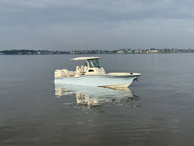 Slide: The Image of Grady-White 281 Coastal Explorer 2026 with twin outboard engines on calm water. - 33