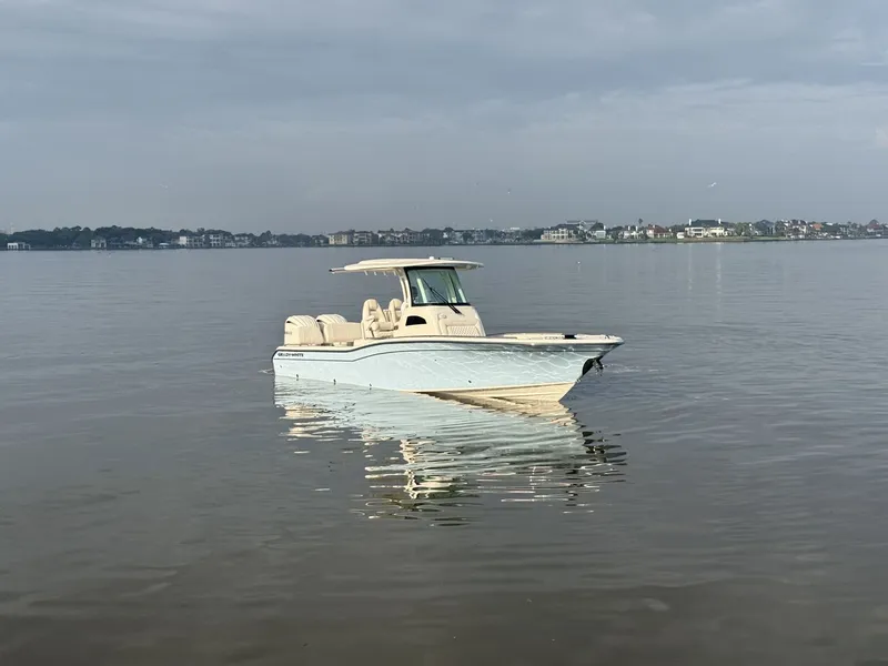 Slide: The Image of Grady-White 281 Coastal Explorer 2026 with dual engines on calm water. - 35