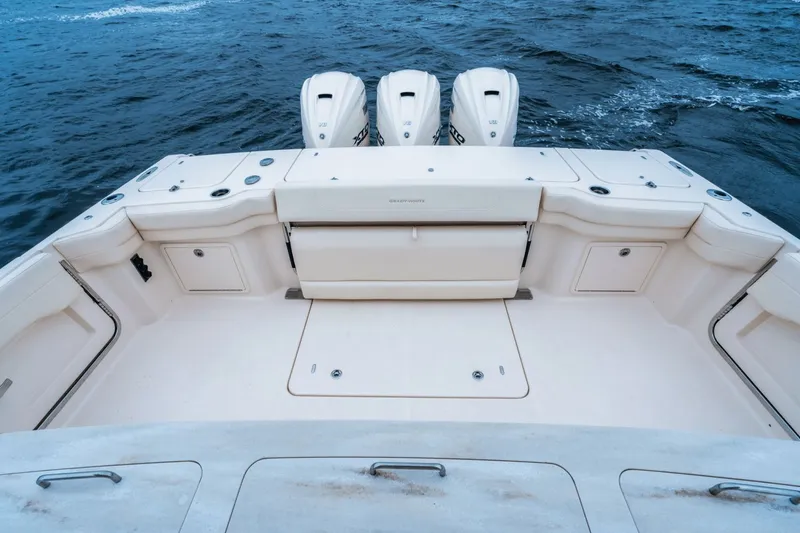 Slide: The Image of Grady-White Canyon 386, 2027 model, featuring a spacious deck and three powerful outboard engines. - 4