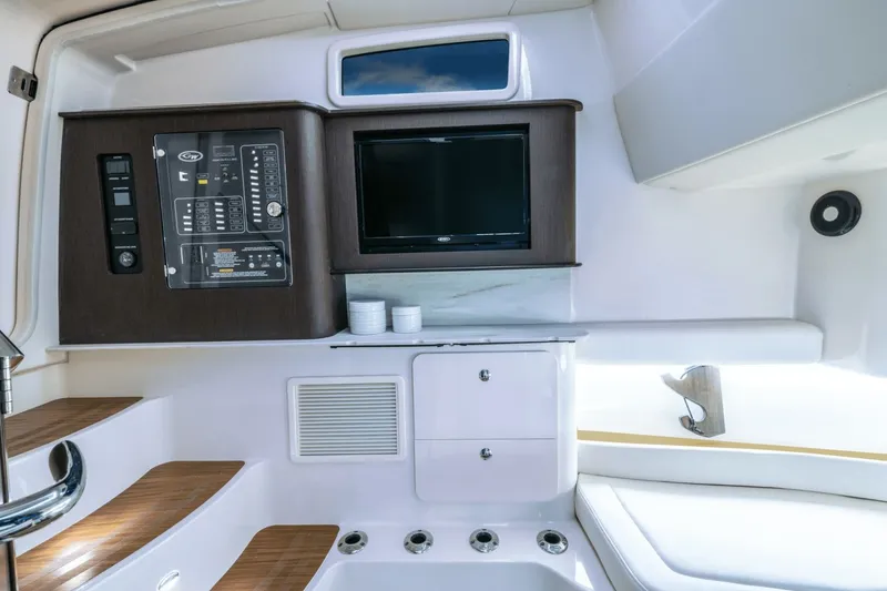 Slide: The Image of Interior of the Grady-White Canyon 386 with wooden steps, control panel, and television. - 13
