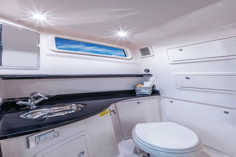 Slide: The Image of Interior of a 2027 Grady-White Canyon 386 featuring a sink, toilet, and storage compartments. - 12