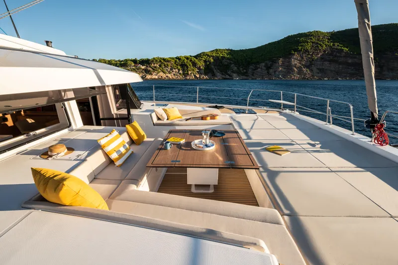 Slide: The Image of Luxurious 2026 Bali 5.8 yacht deck with seating, table, and ocean view. - 13