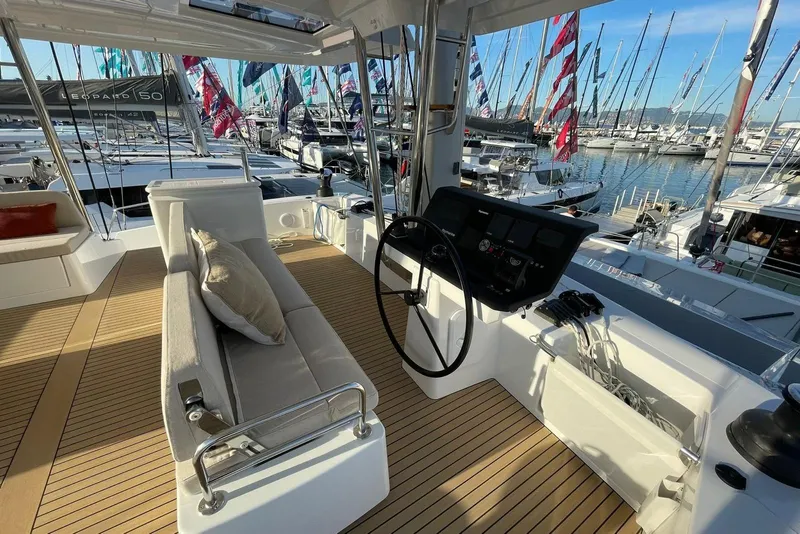 Slide: The Image of Modern Bali 5.8 yacht interior with helm, seating, and marina view, 2026 model. - 15