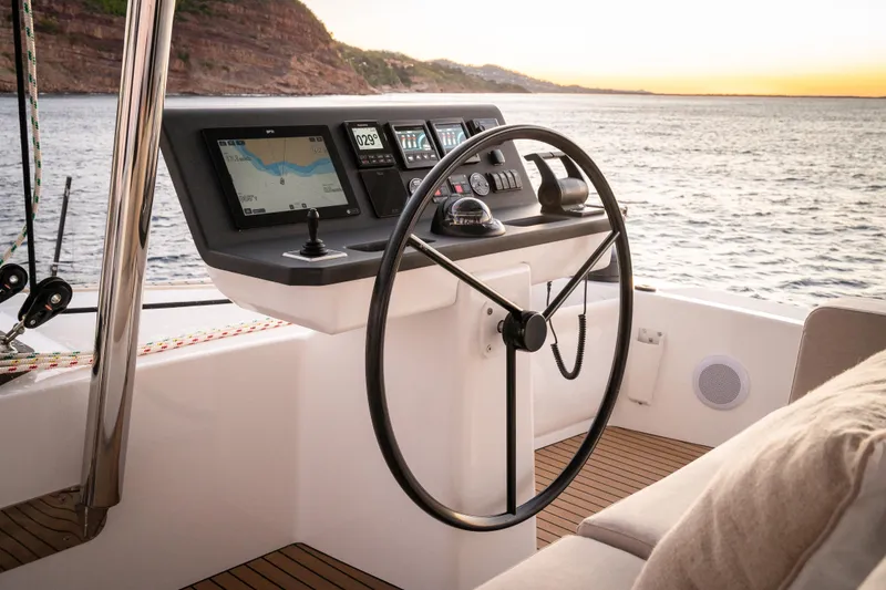 Slide: The Image of Steering wheel and navigation panel on 2026 Bali 5.8 yacht at sunset. - 16