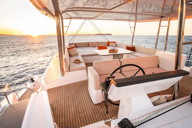 Slide: The Image of Luxurious 2026 Bali 5.8 yacht deck at sunset, featuring elegant seating and ocean views. - 17