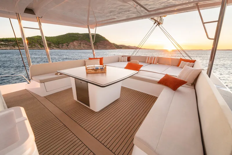Slide: The Image of Luxurious Bali 5.8 yacht deck with sunset view, featuring comfortable seating and elegant design, 2026 model. - 18