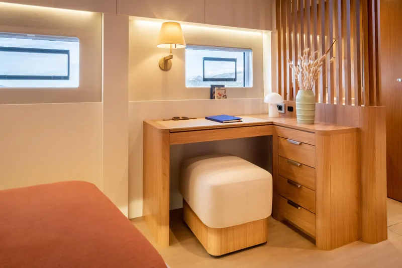 Slide: The Image of Luxurious interior of 2026 Bali 5.8 yacht with elegant wooden desk and cozy seating. - 25