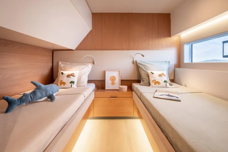 Slide: The Image of Modern twin cabin interior in 2026 Bali 5.8 yacht, featuring cozy beds and decorative pillows. - 27