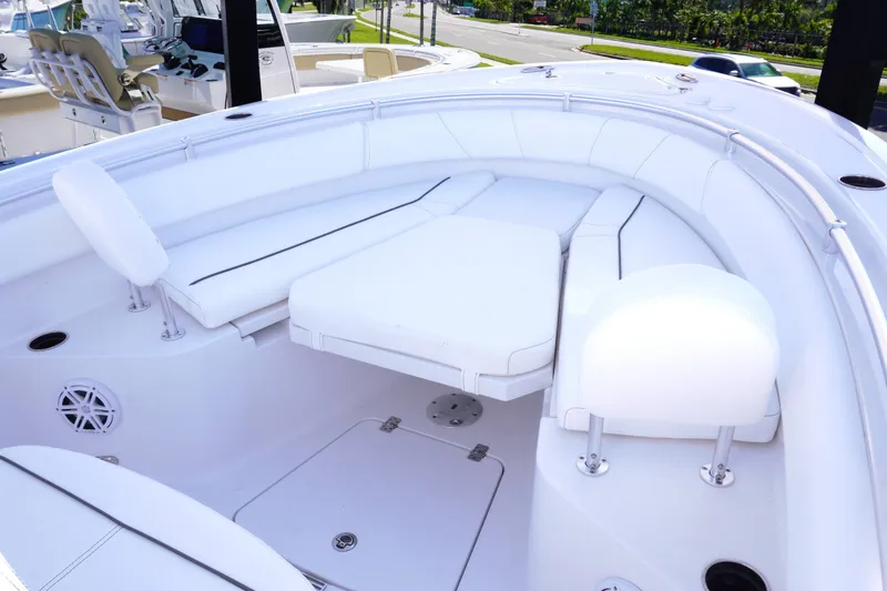 Slide: The Image of 2026 Sportsman Open 232 Center Console boat interior with white cushioned seating. - 19