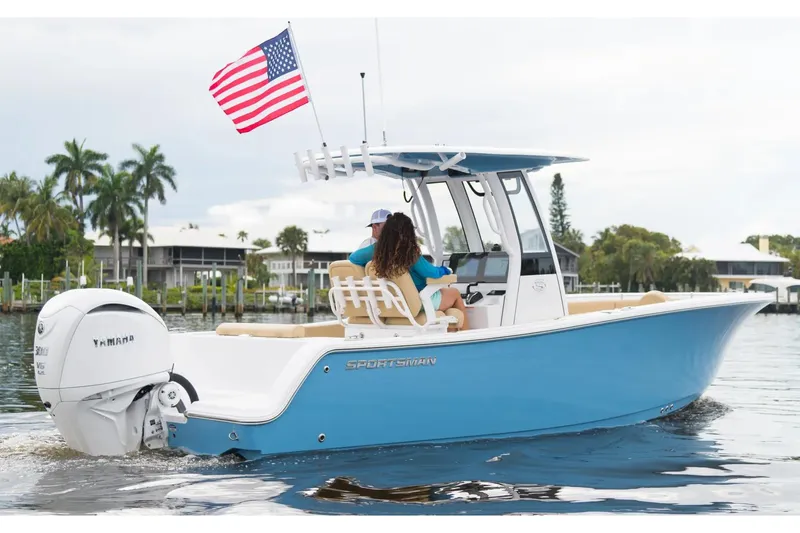Slide: The Image of Manufacturer Provided Image: 2025 Sportsman Open 232 Center Console boat on water, American flag, tropical background. - 2
