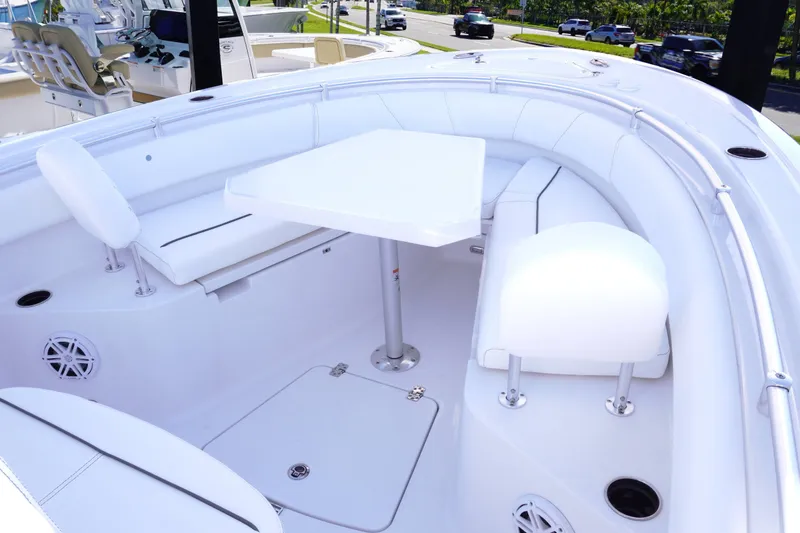 Slide: The Image of 2026 Sportsman Open 232 Center Console boat interior with seating and table. - 20
