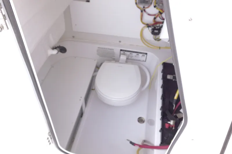 Slide: The Image of Interior of 2026 Sportsman Open 232 Center Console boat with toilet and wiring. - 22