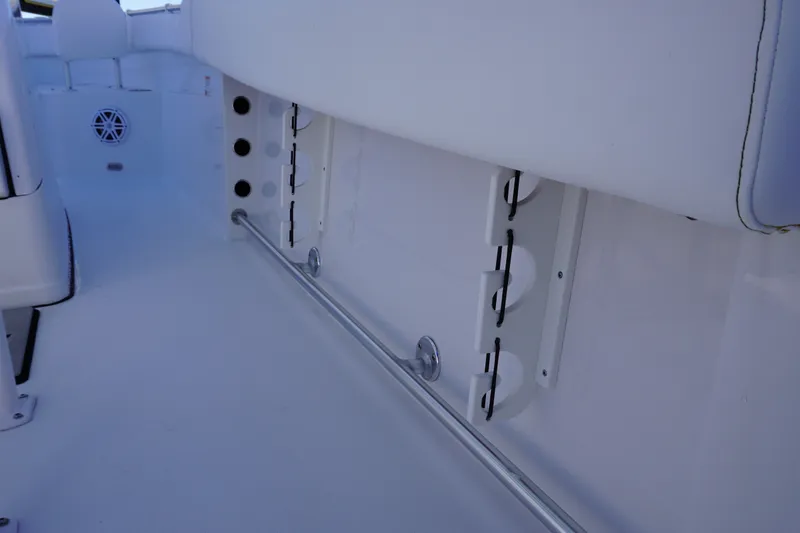 Slide: The Image of Interior view of 2026 Sportsman Open 232 Center Console boat, featuring rod holders and seating. - 13