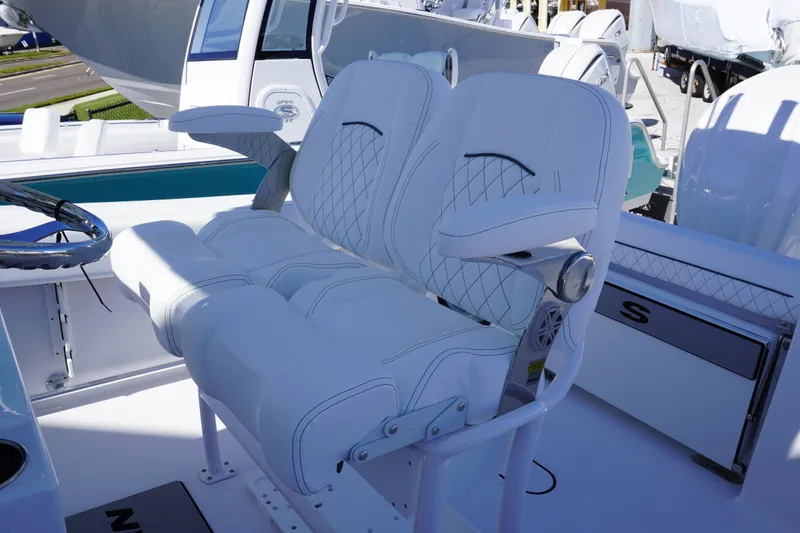 Slide: The Image of 2026 Sportsman Open 232 Center Console boat with luxurious white seating and steering wheel. - 10