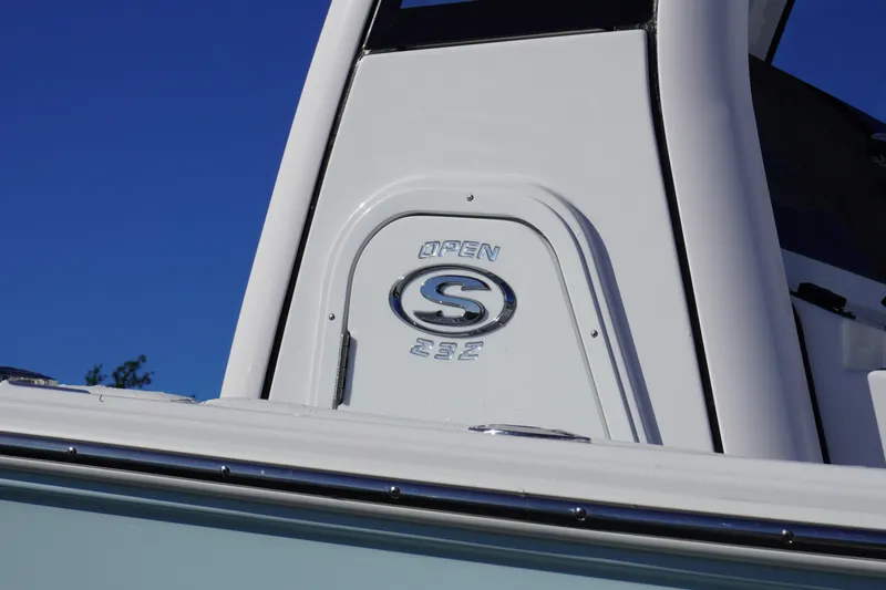 Slide: The Image of 2026 Sportsman Open 232 Center Console boat detail against clear blue sky. - 2