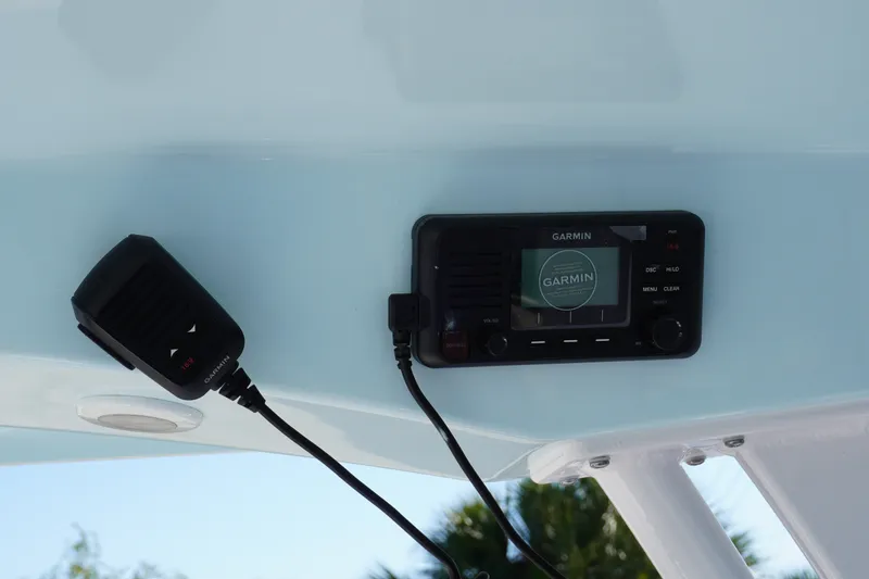 Slide: The Image of Garmin marine radio and microphone on 2026 Sportsman Open 232 Center Console boat. - 12