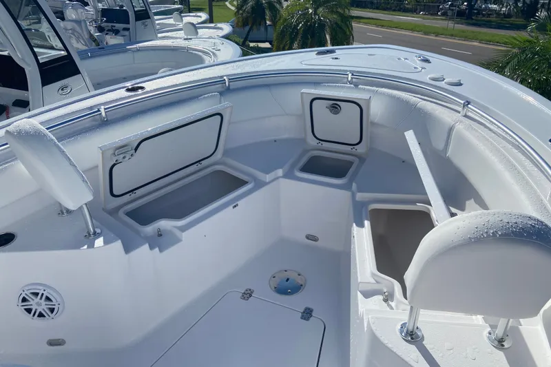 Slide: The Image of 2026 Sportsman Heritage 231 Center Console boat interior with storage compartments and seating. - 13