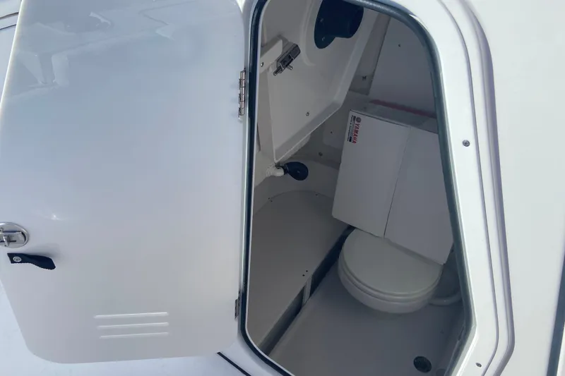 Slide: The Image of 2026 Sportsman Heritage 231 Center Console boat interior with open storage compartment. - 15