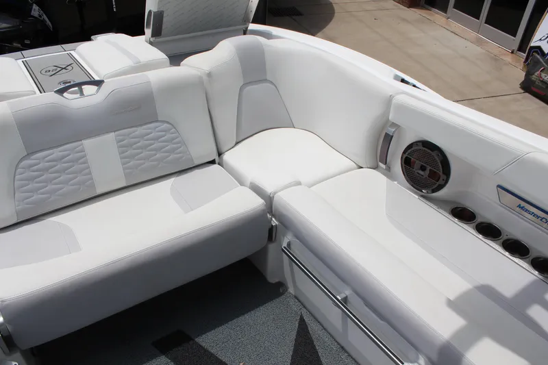 Slide: The Image of 2019 MasterCraft X26 boat interior with white leather seating and built-in speaker. - 11