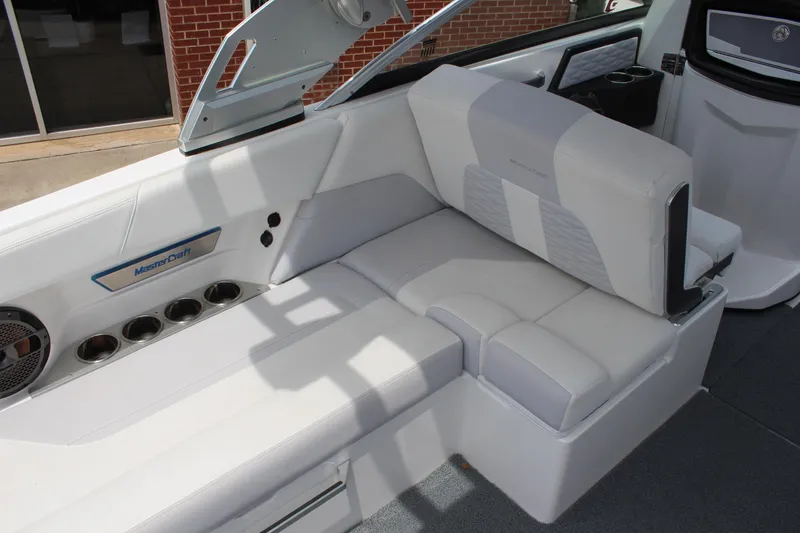 Slide: The Image of 2019 MasterCraft X26 boat interior with white seating and cup holders. - 12