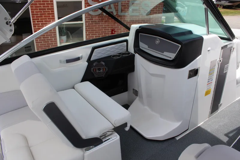 Slide: The Image of 2019 MasterCraft X26 boat interior with white seating and modern dashboard design. - 13