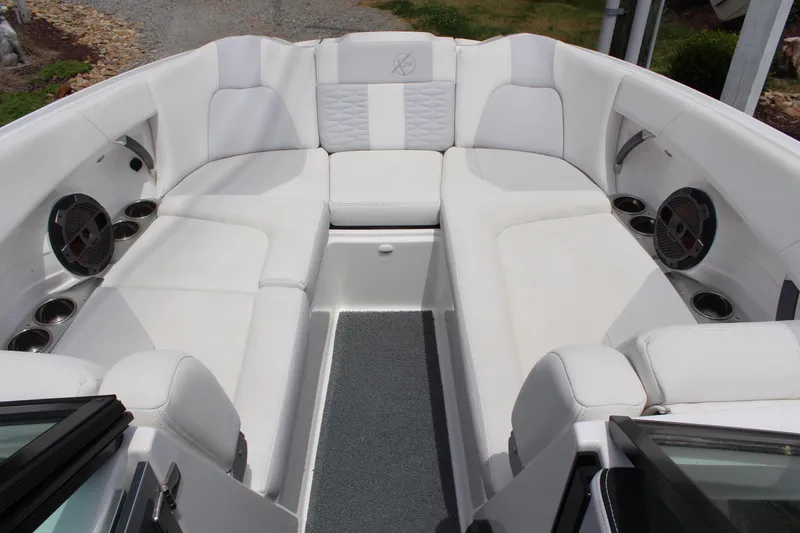 Slide: The Image of 2019 MasterCraft X26 boat interior with white seating and cup holders. - 5
