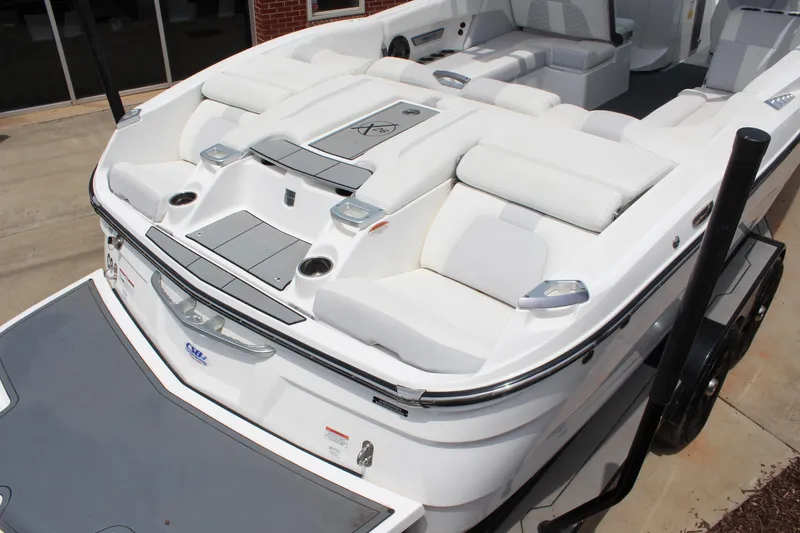 Slide: The Image of 2019 MasterCraft X26 boat with luxurious white seating and sleek design. - 6