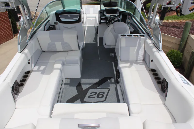 Slide: The Image of 2019 MasterCraft X26 boat interior with white seating and modern dashboard. - 8