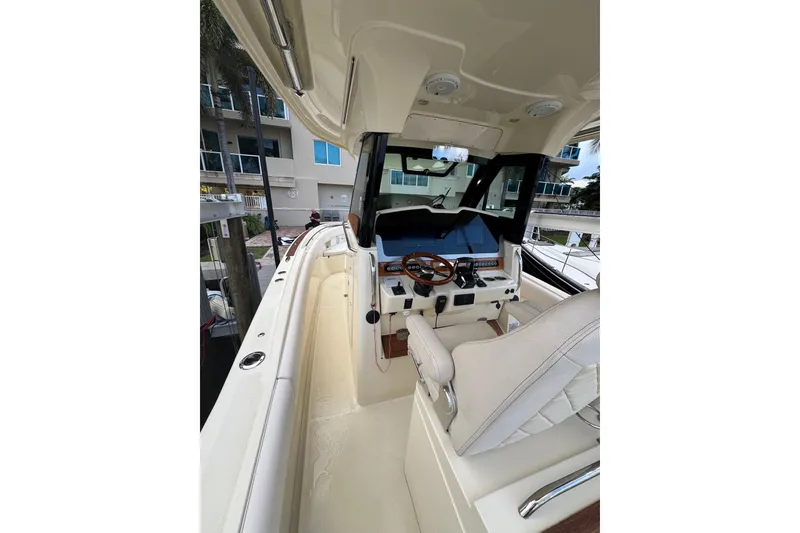 Slide: The Image of 2023 Chris-Craft Catalina 30 helm with modern controls and luxurious seating. - 12